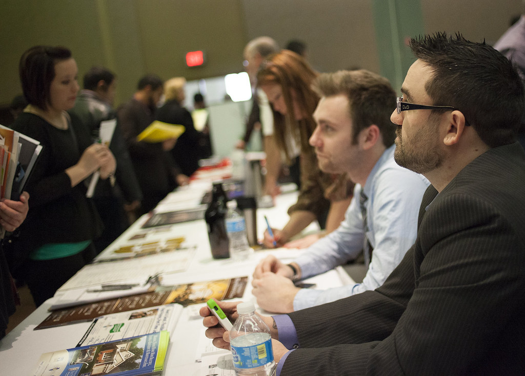 Professionals speaking at a networking table during an event